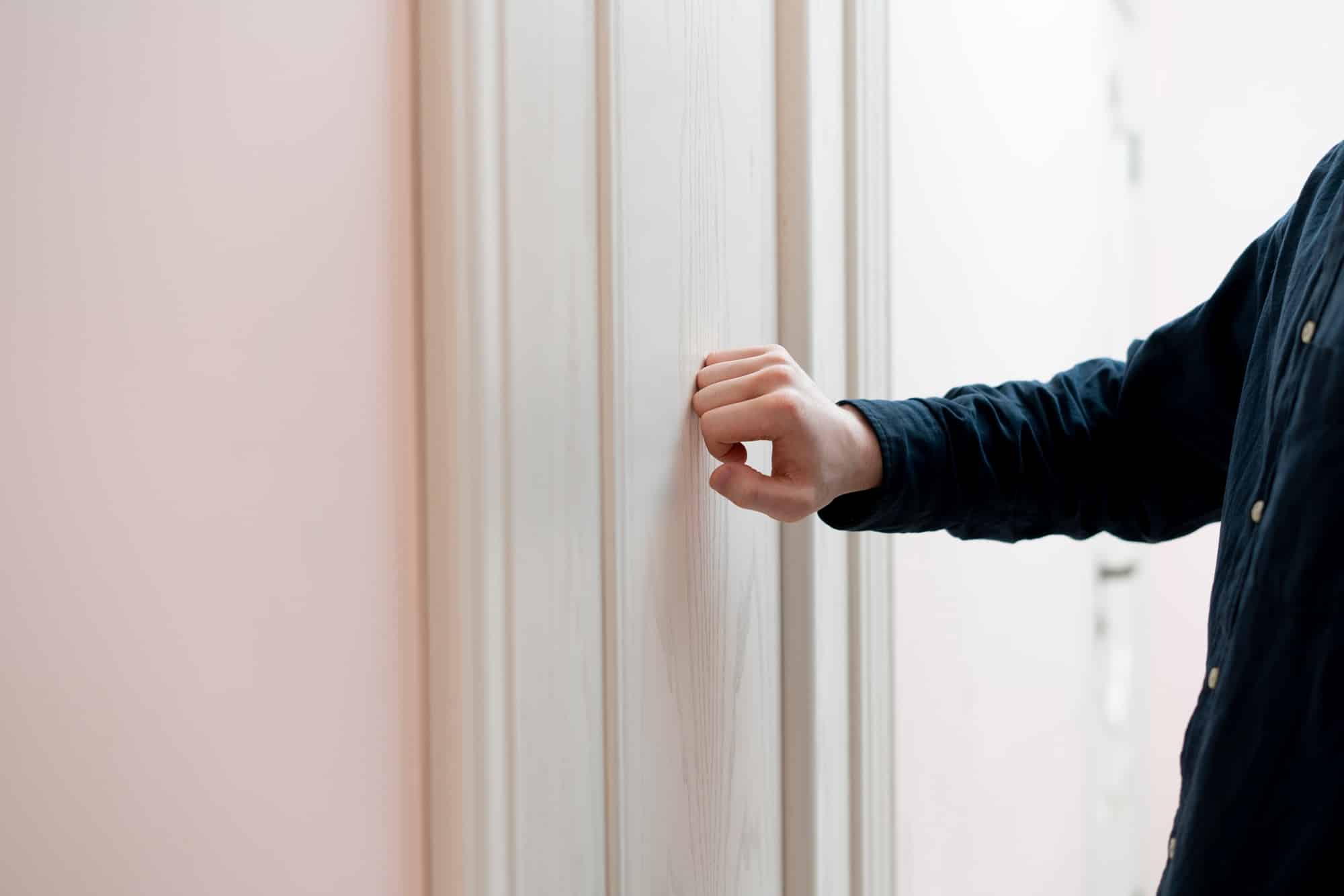 a person hand knock the door, visit the friends house