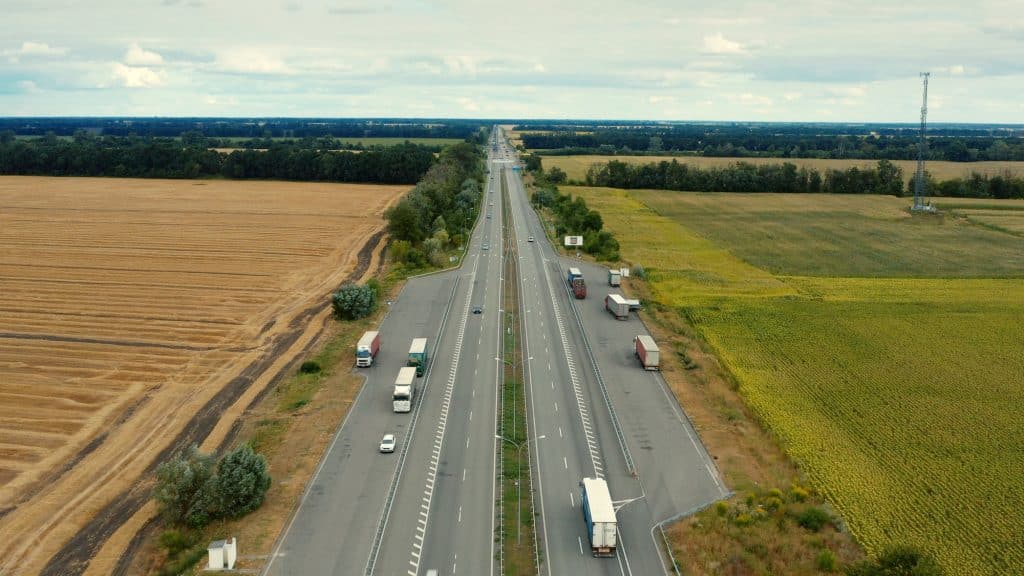 Aerial view of a motorway in summer on a cloudy day.
