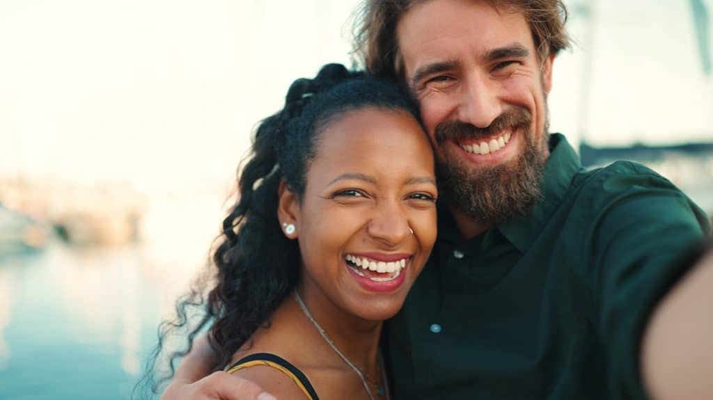 Close-up portrait of Interracial couple. Closeup portrait woman and man hugging