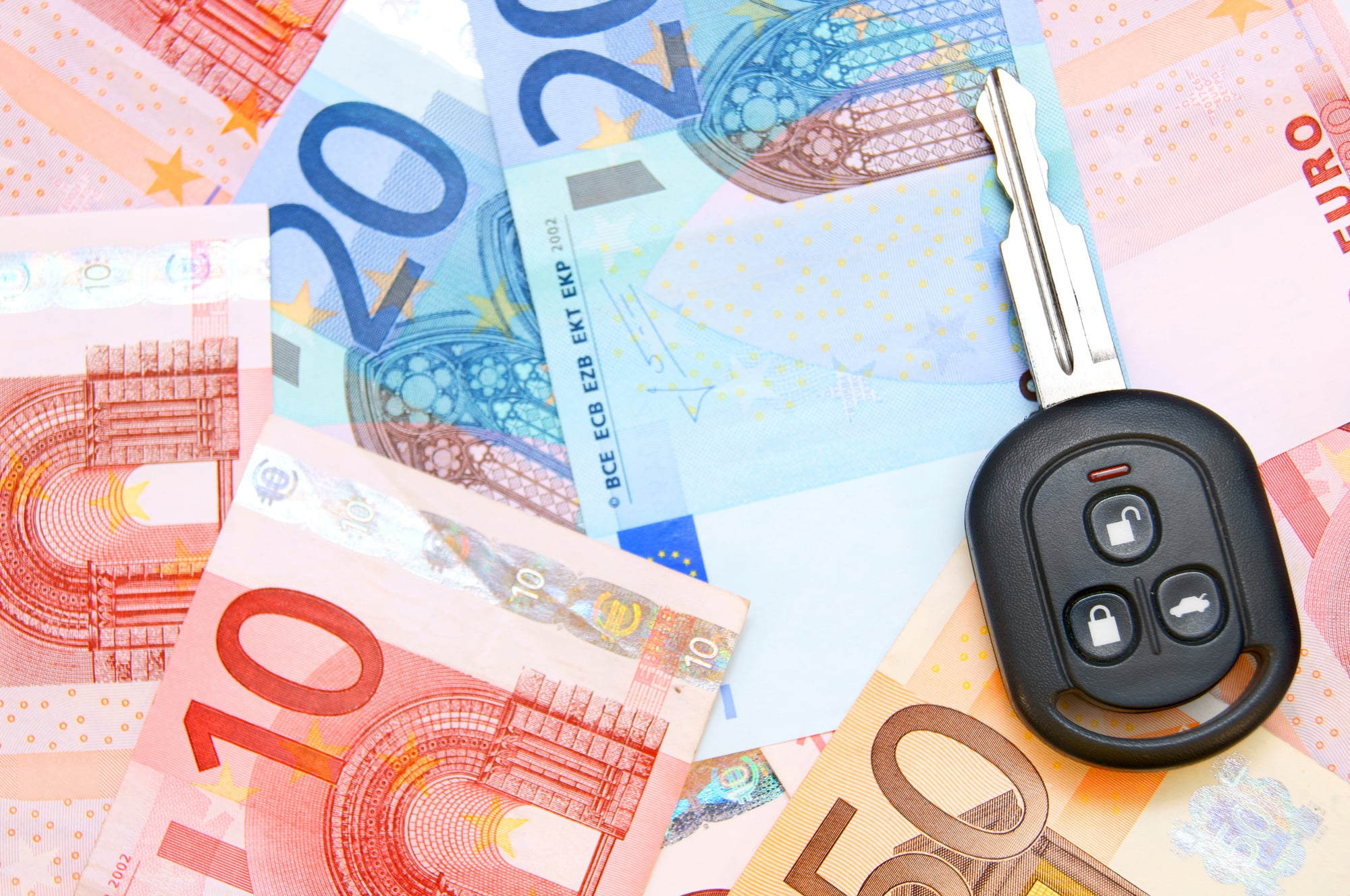 Keys from car on euro banknotes.