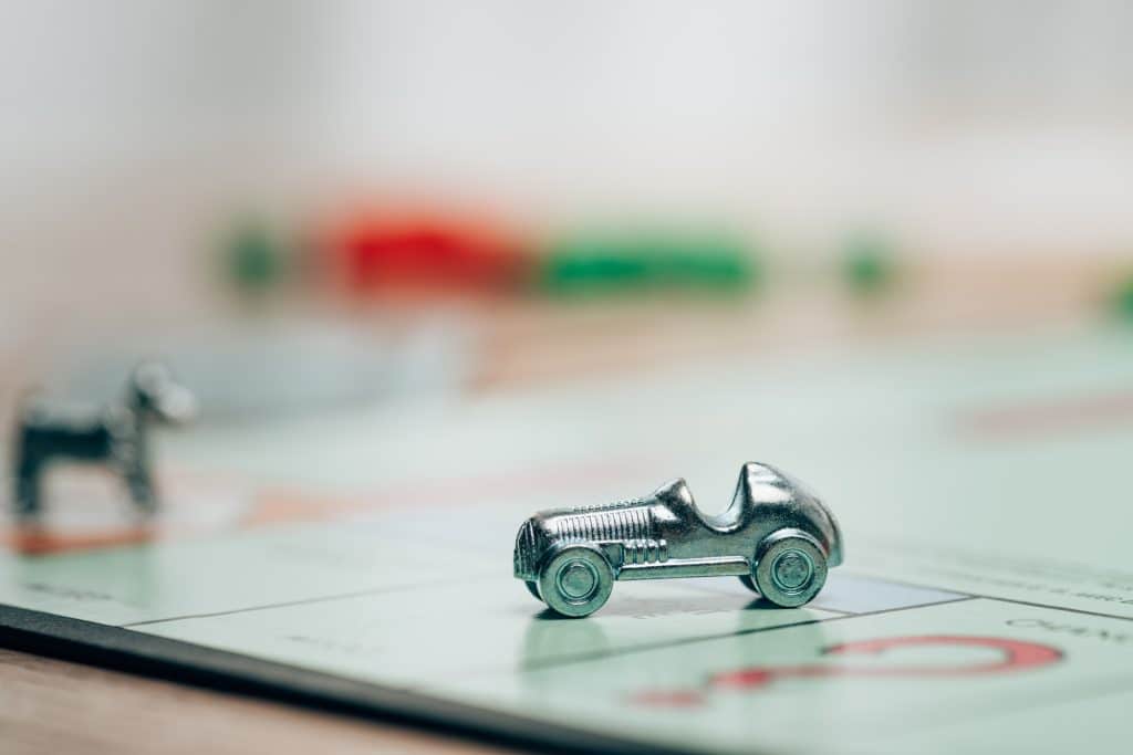 KYIV, UKRAINE - NOVEMBER 15, 2019: Selective focus of playing figure on monopoly game on table