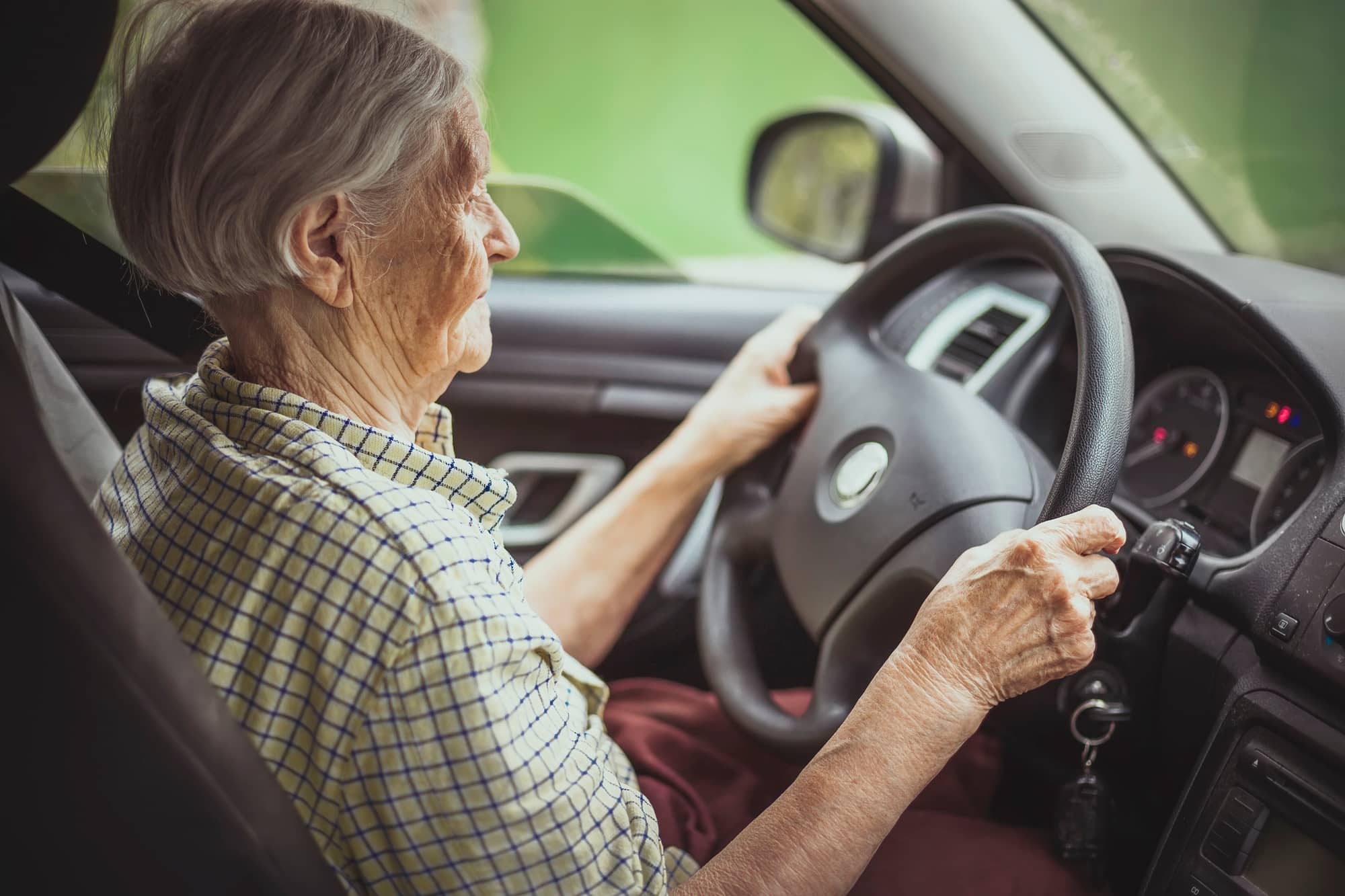 Senior woman driving car