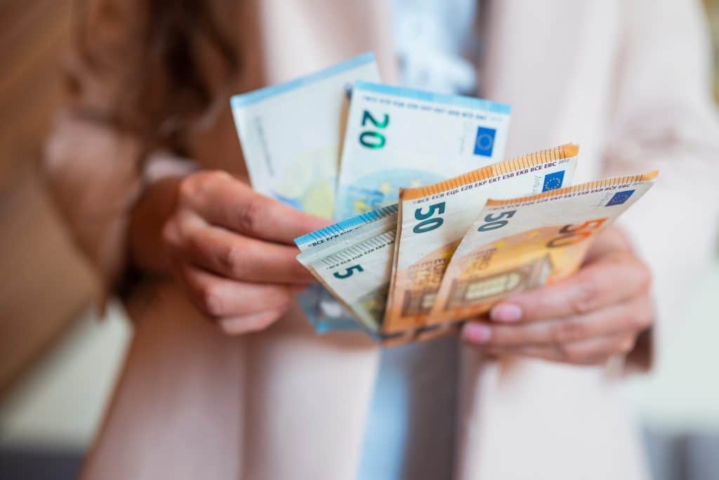 a girl holds banknotes money euro in her hands for payment