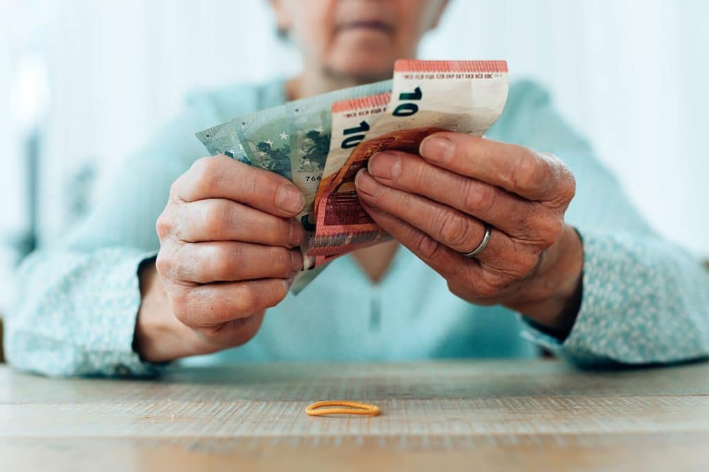 focus in foreground on the hands of hold woman counting cash money