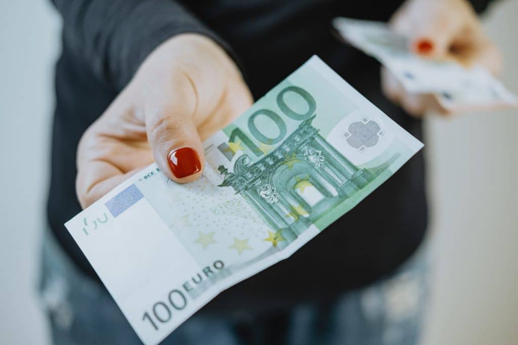 100 euro in Women's hands and a wallet